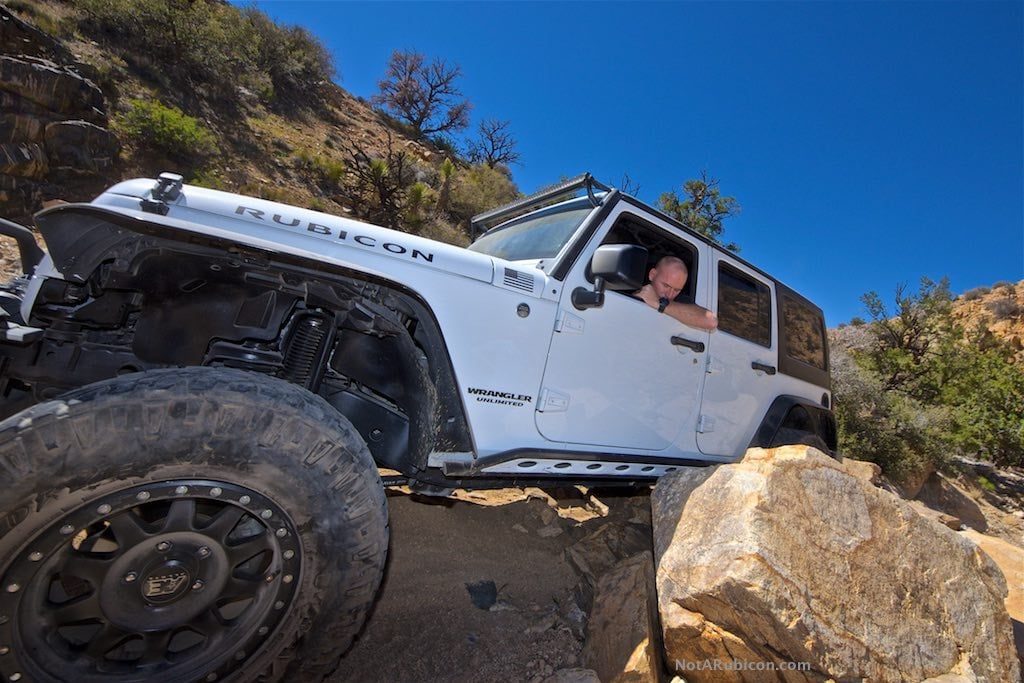 White Jeep going over rocks