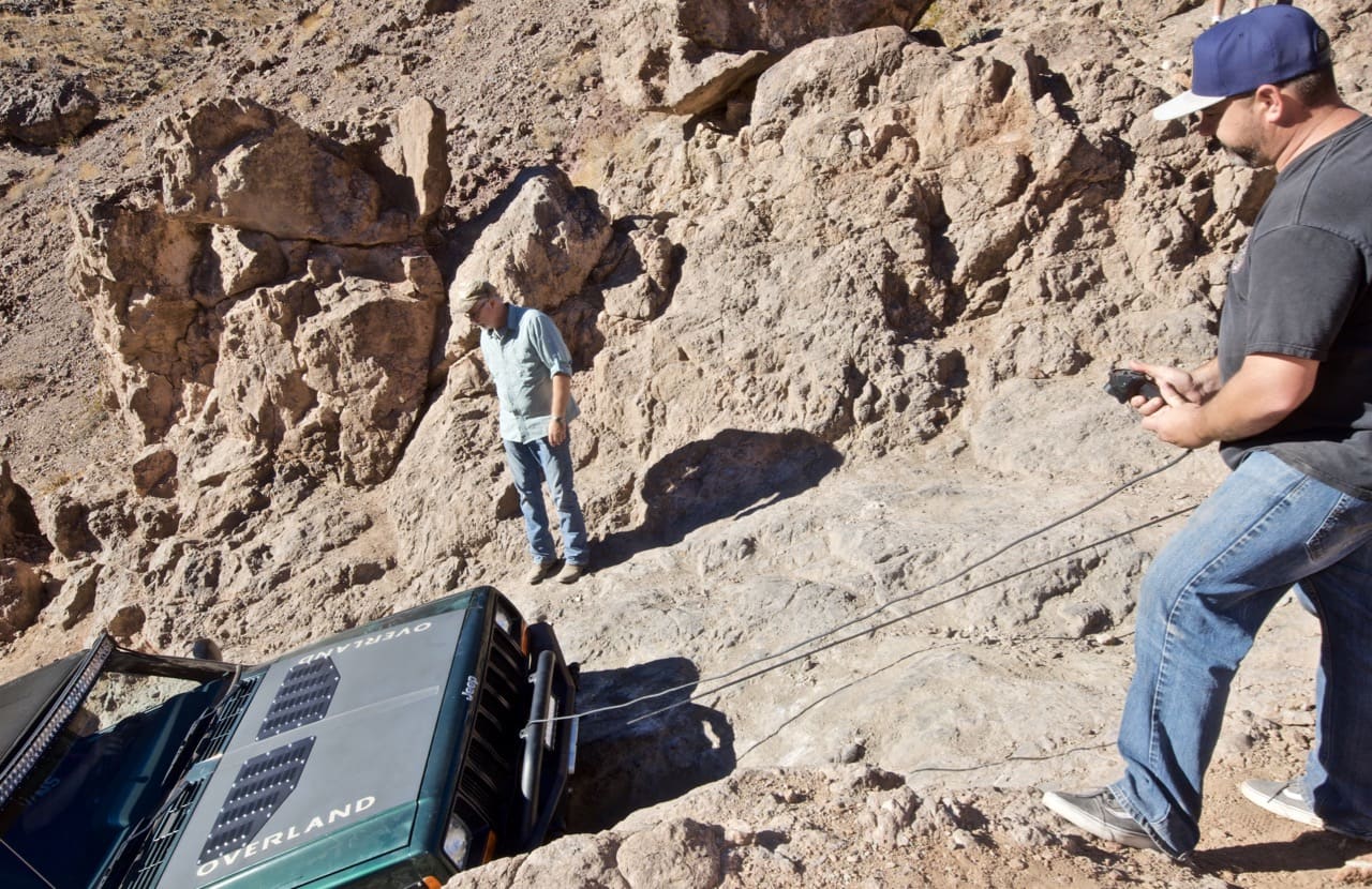 A Jeep Cherokee getting winched up a ledge on Doran Scenic Road