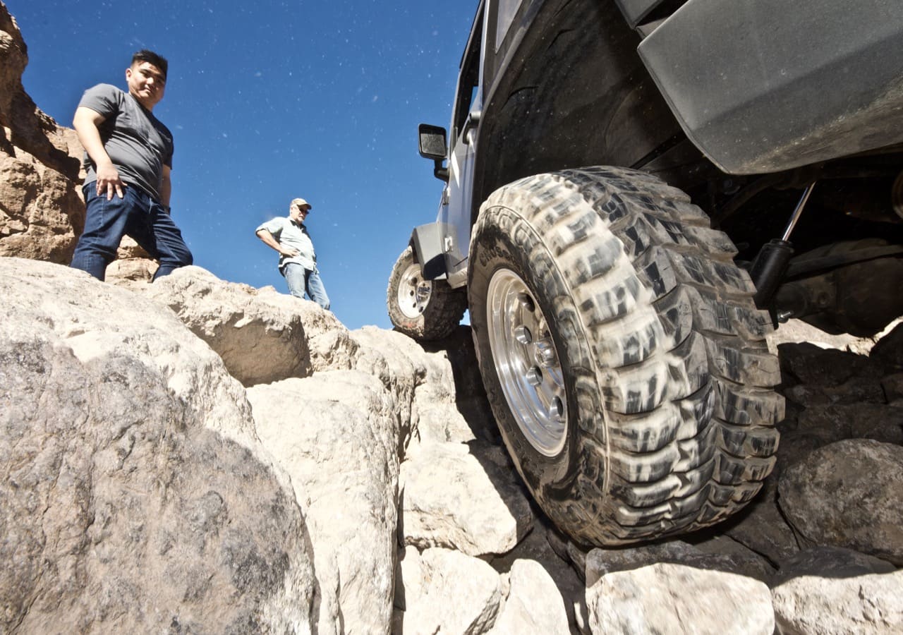 Jeep Wrangler tire going over a ledge on the off-road trail near Calico Ghost Town